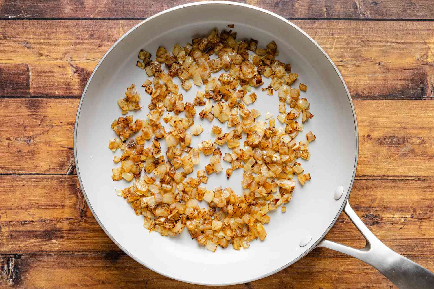 caramelized onions in a skillet for cheeseburger stuffed baked potatoes recipe