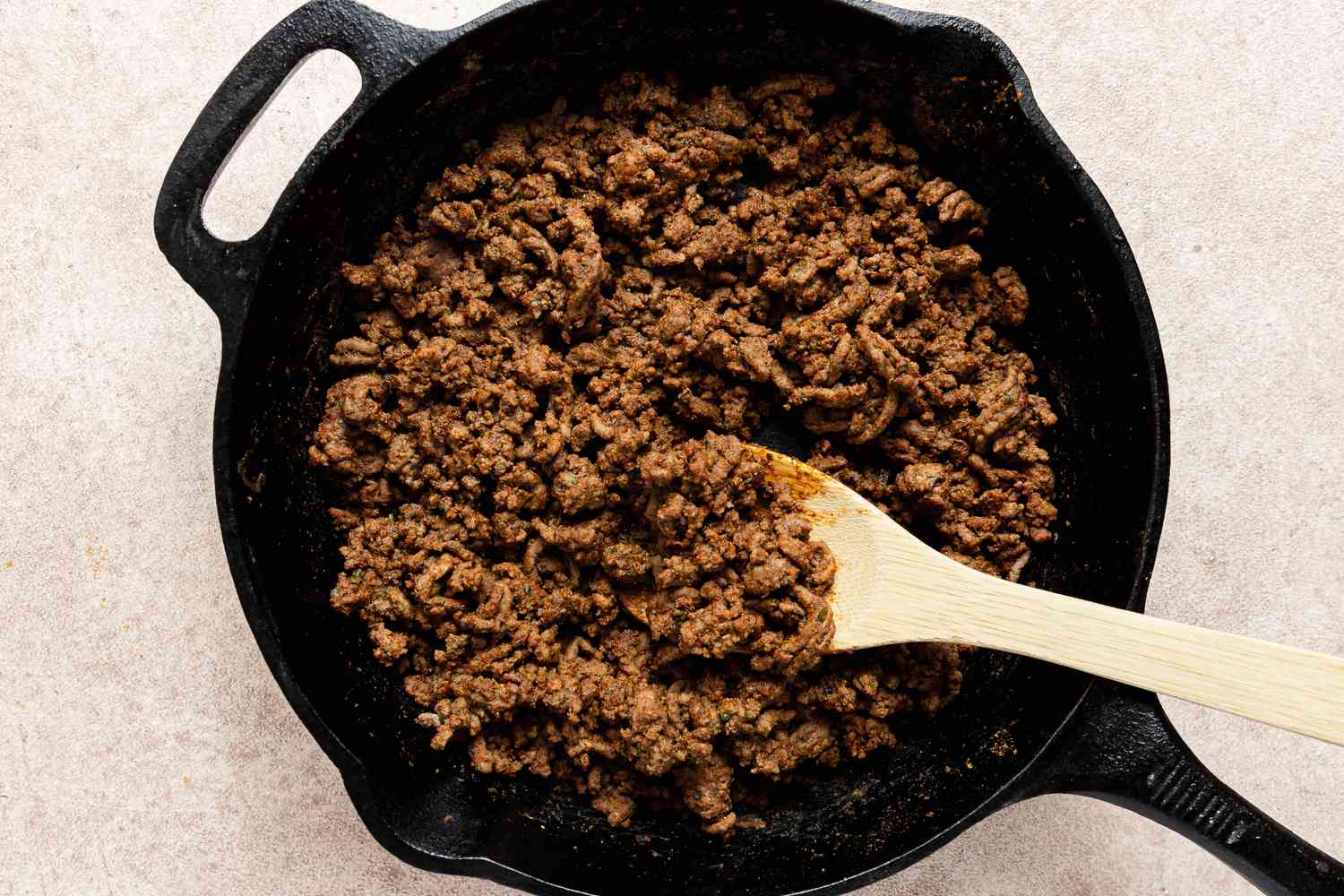Ground Beef Cooked in a Caste Iron Skillet for Copycat Crunchwrap Supreme Recipe