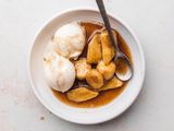 Plate of Bananas Foster with Scoops of Vanilla Ice Cream