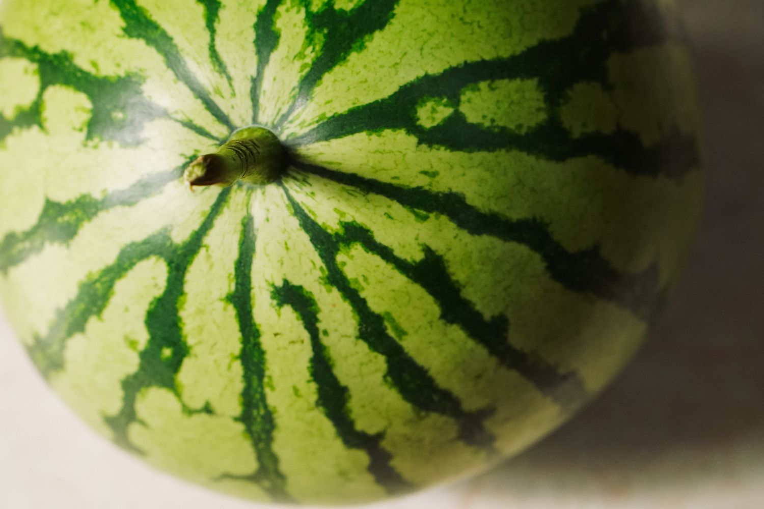 A watermelon with visible rind patterns placed on a surface