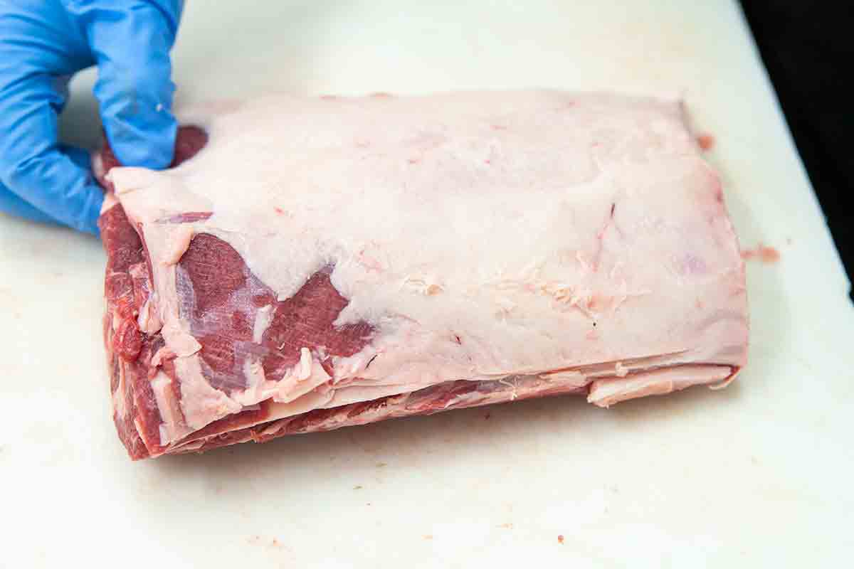 score the ends of the rack of lamb