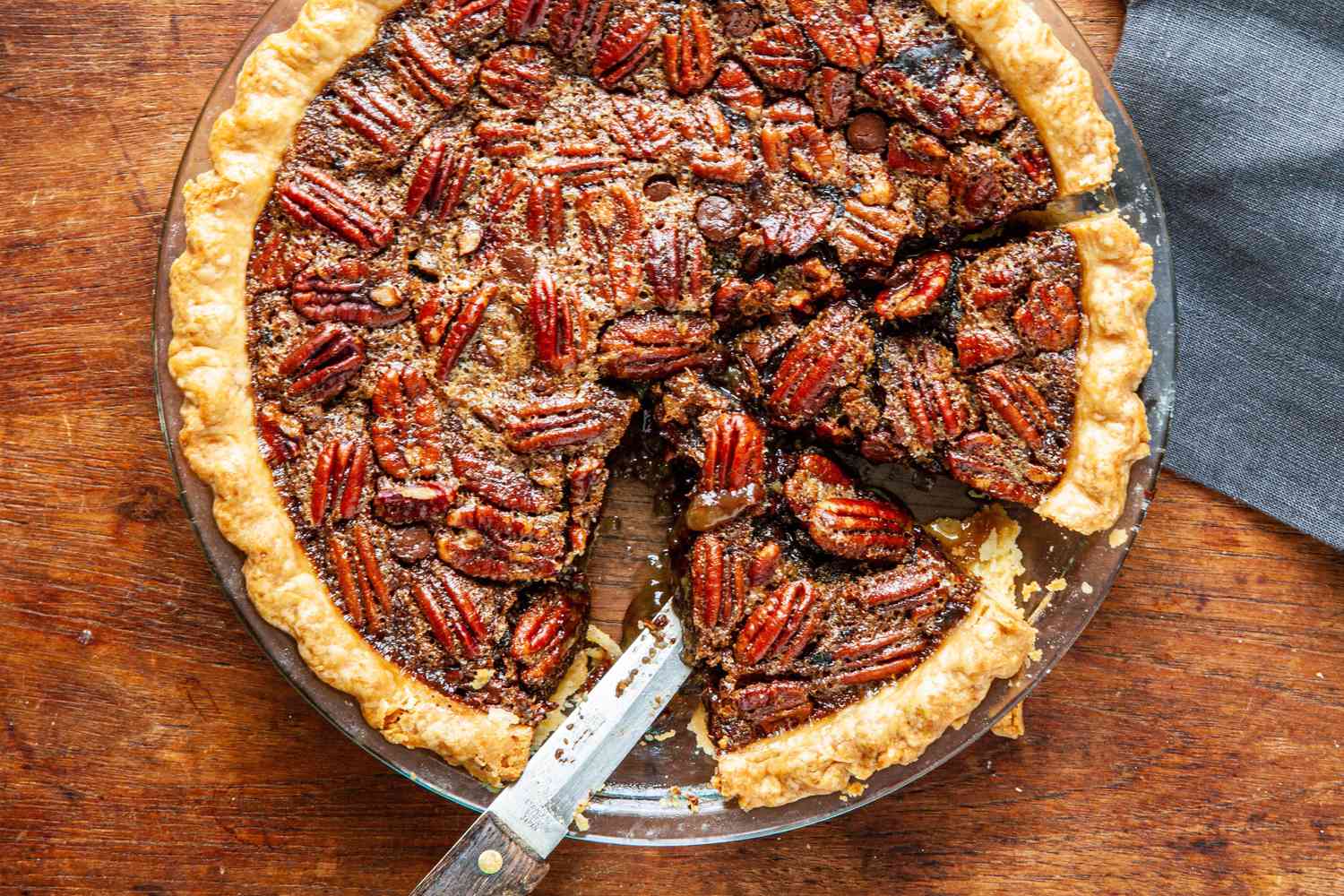 Chocolate pecan pie with bourbon with a couple slices cut.