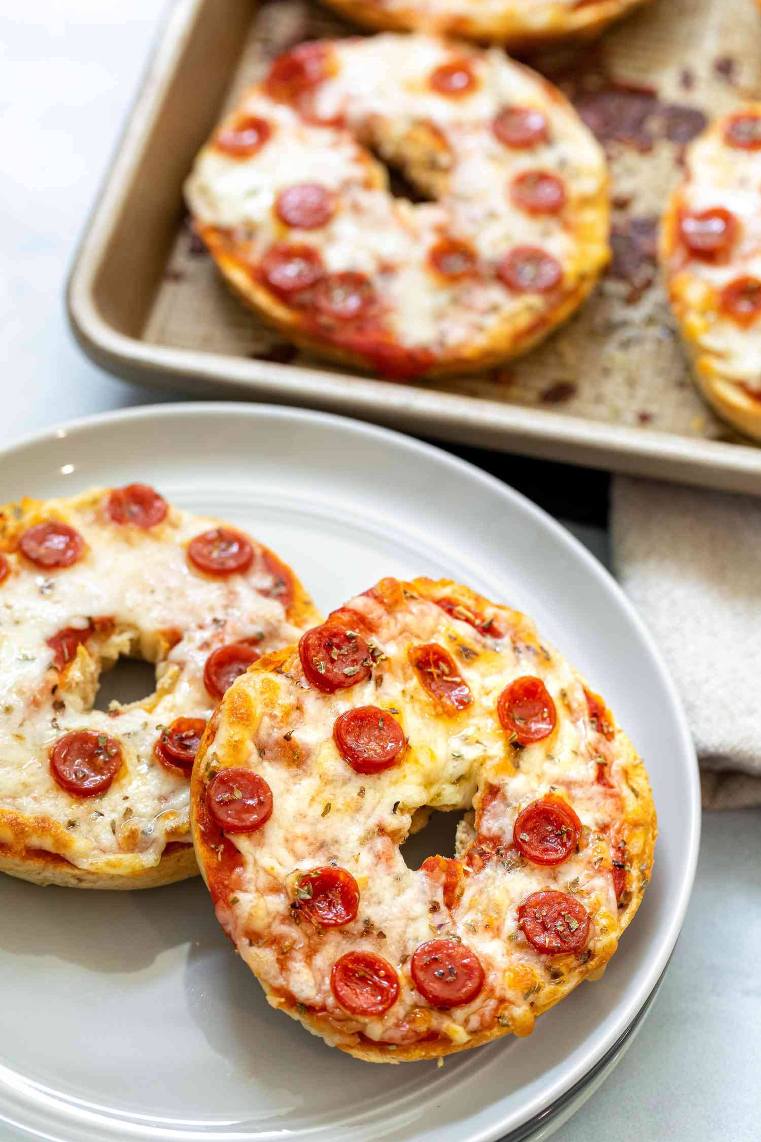 Pizza bagel on a grey plate. 