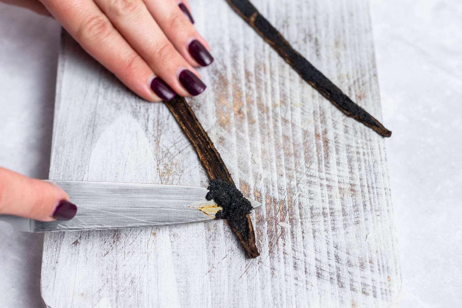 Slicing vanilla beans for an easy no bake cheesecake.
