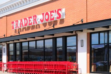 A Trader Joe's storefront with shopping carts arranged outside