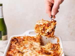 baked spaghetti casserole being served from a dish