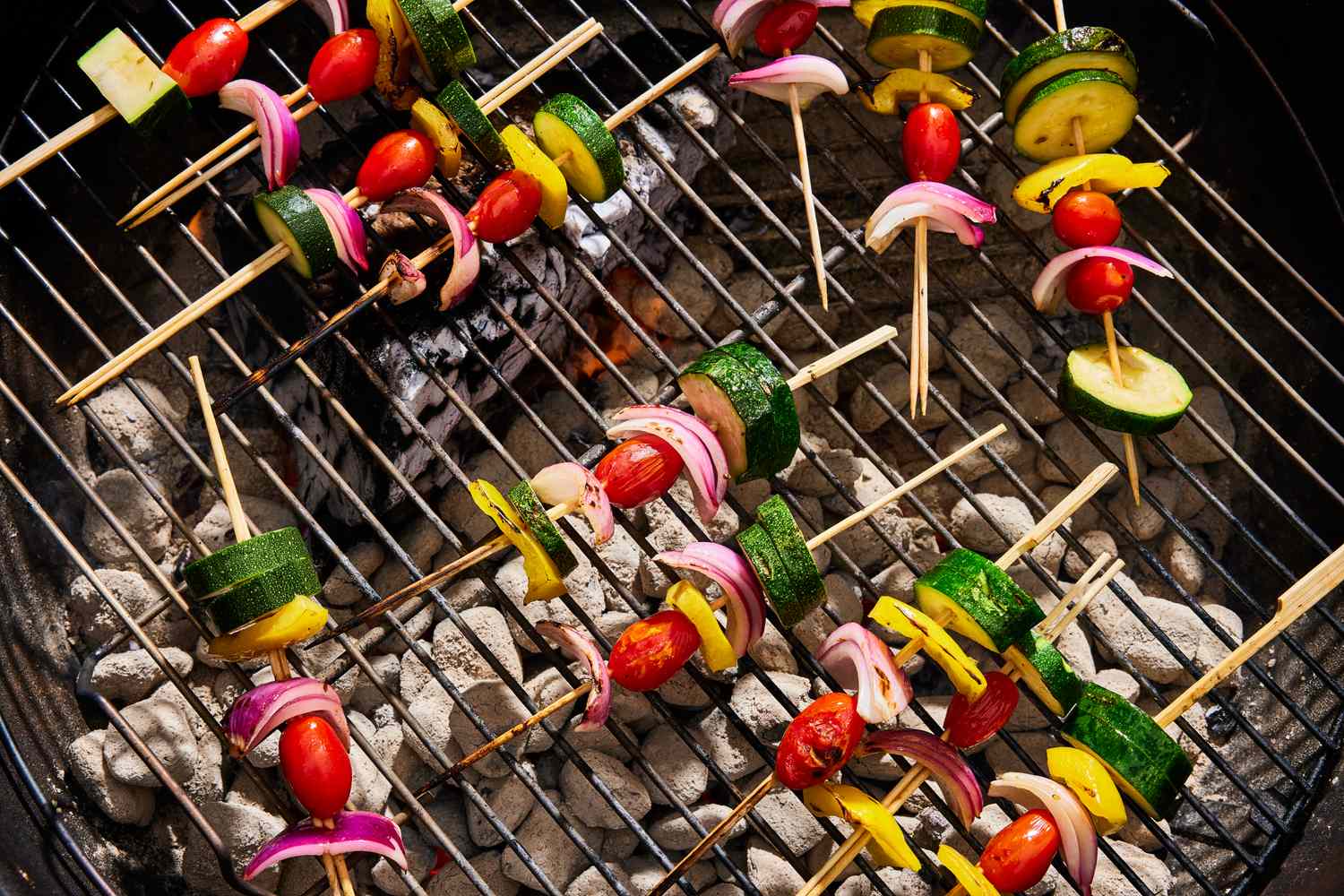 Vegetable skewers cooking on a grill
