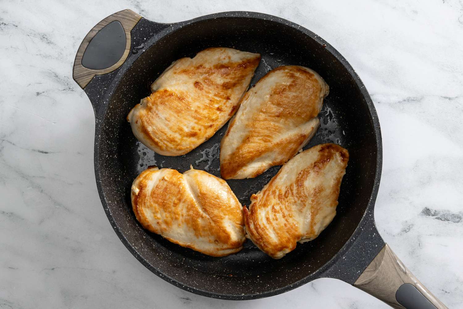 chicken seared in a pan for creamy coconut lime chicken recipe 