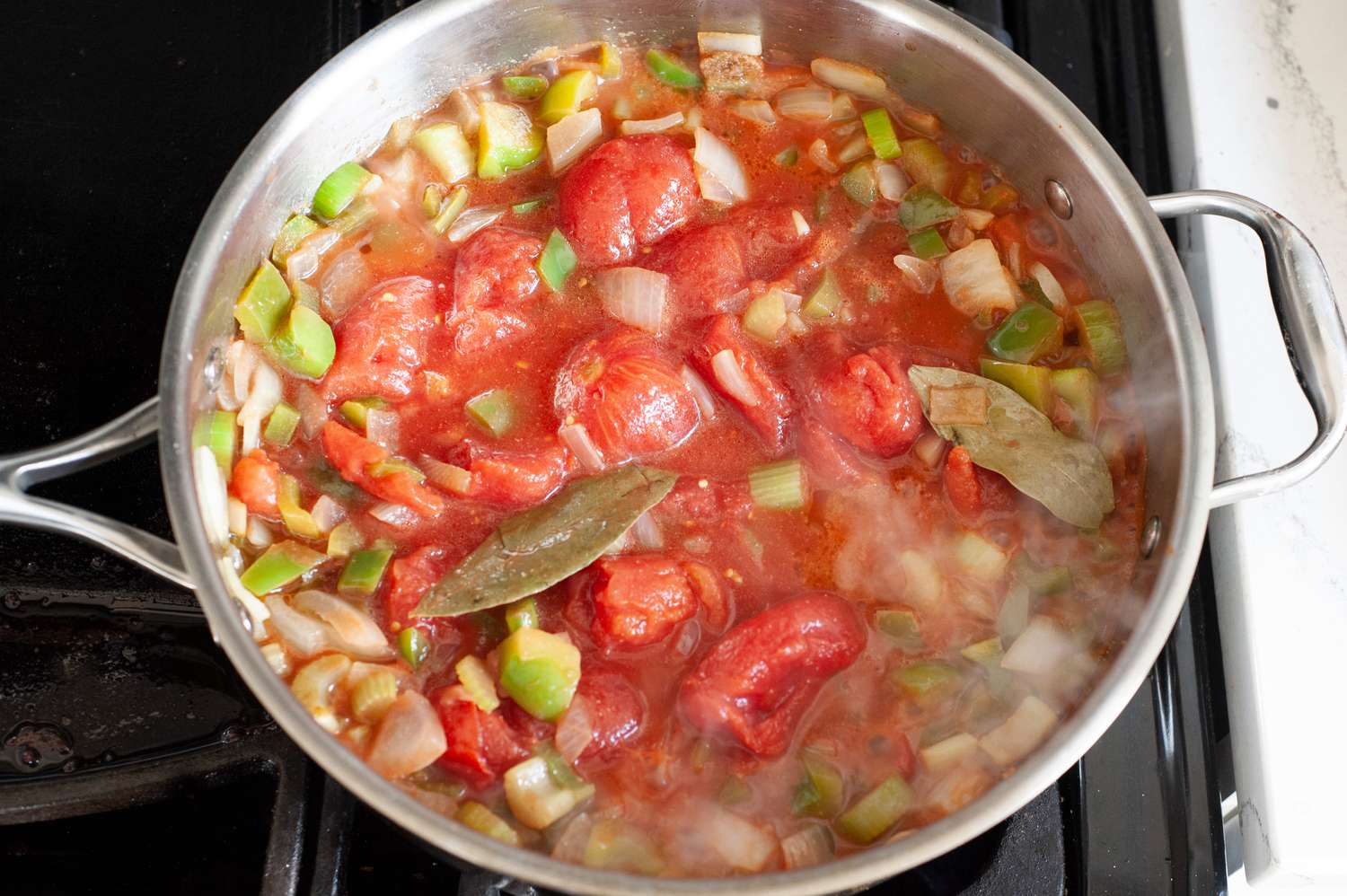 Tomatoes added to sauteed veggies for shrimp creole