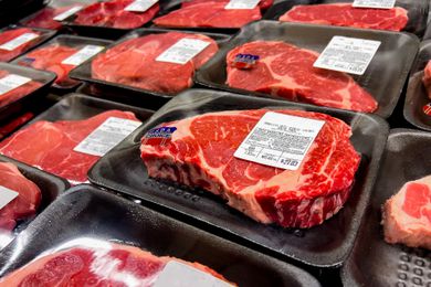A store shelf with pre-packed steaks