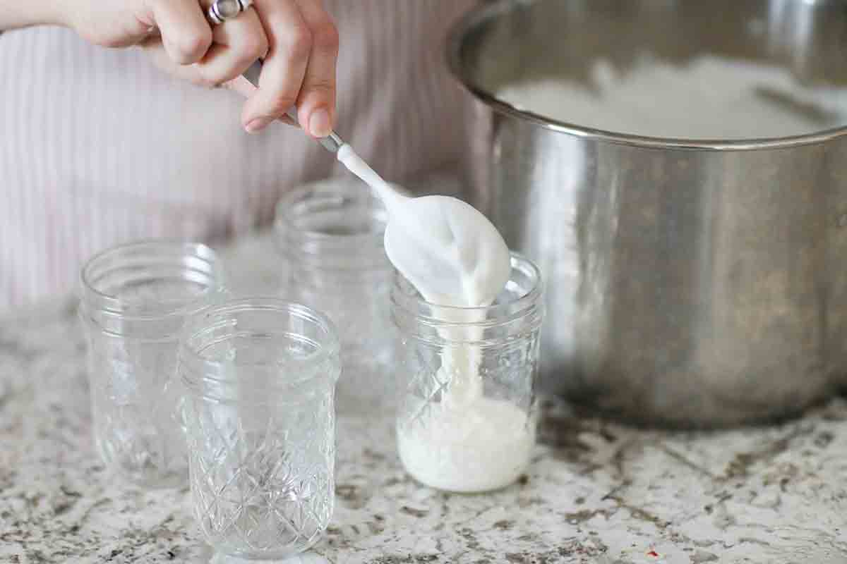 Homemade Yogurt in an Instant Pot being transferred into jars 