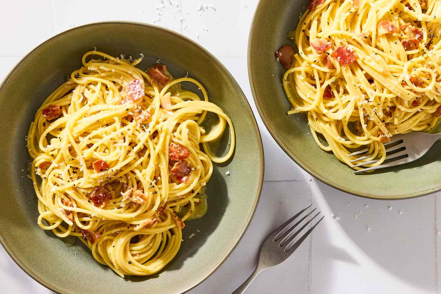 Two bowls os pasta carbonara, ready to serve and eat