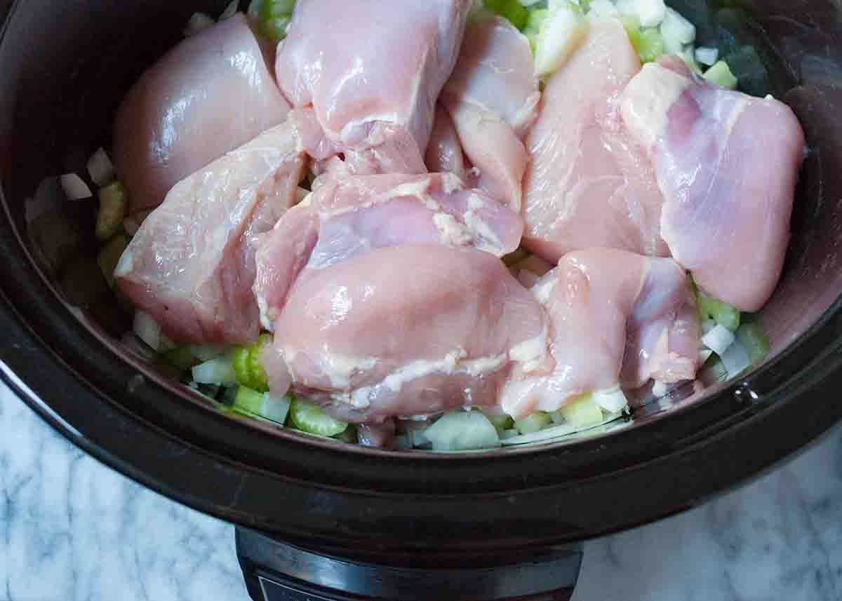 Nestle the chicken into the vegetables inside the slow cooker liner