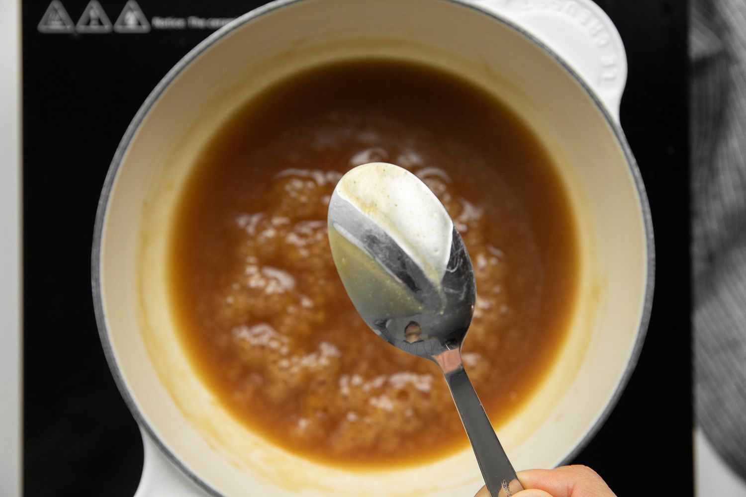Consistency of Sauce Shown Using a Spoon with the Sauce Boiling Blow for Egg Foo Young Recipe