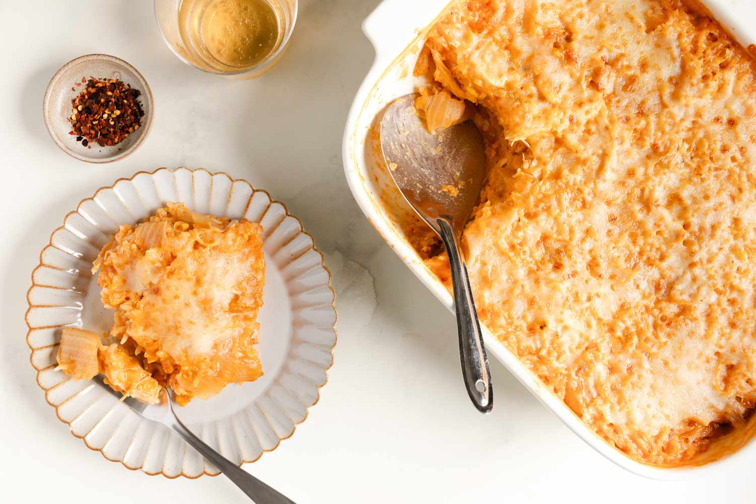 Chicken, Corn, and Tangy Cabbage Casserole in a baking dish, one serving scooped out on a dish with a fork