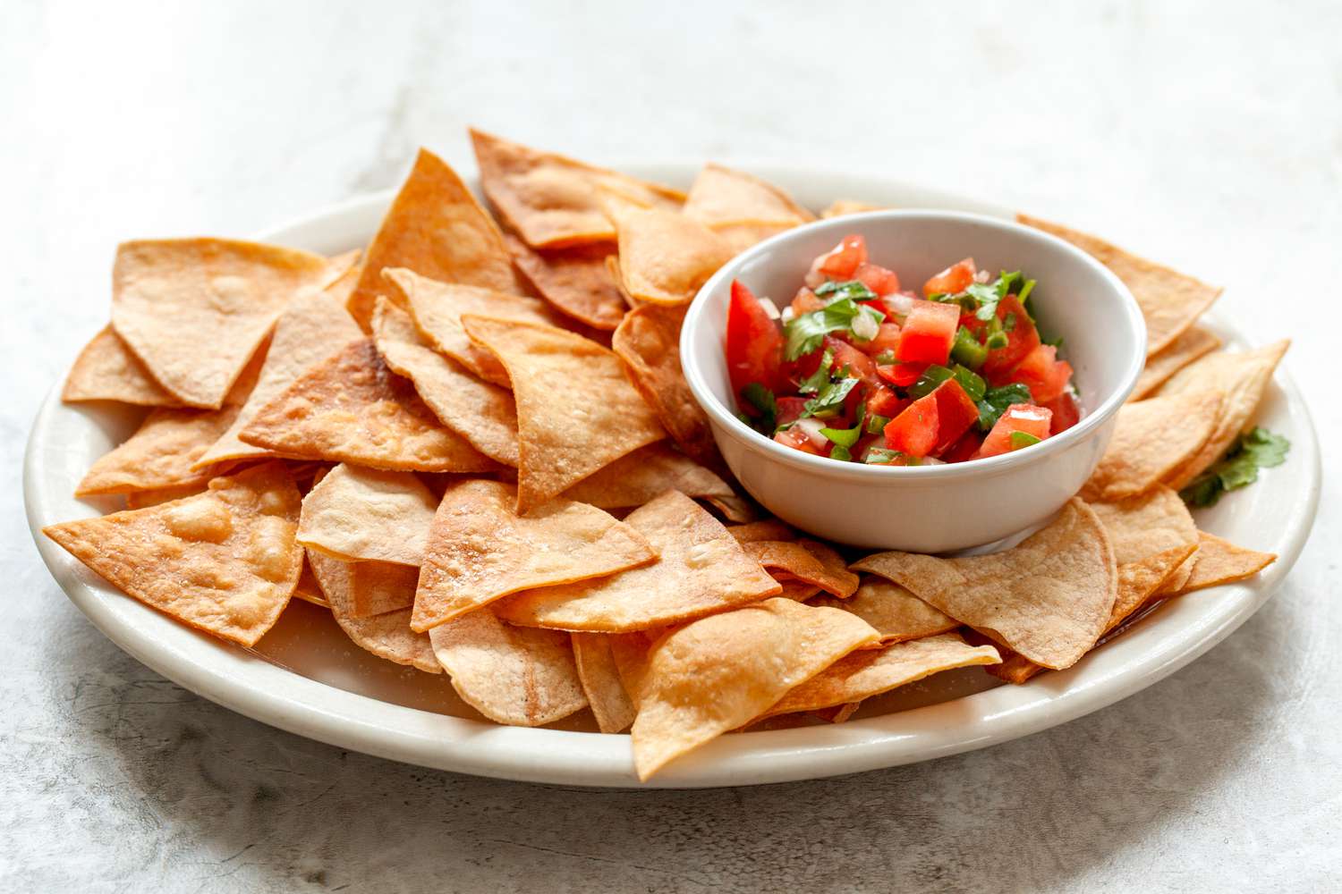 A platter of homemade chips and salsa.