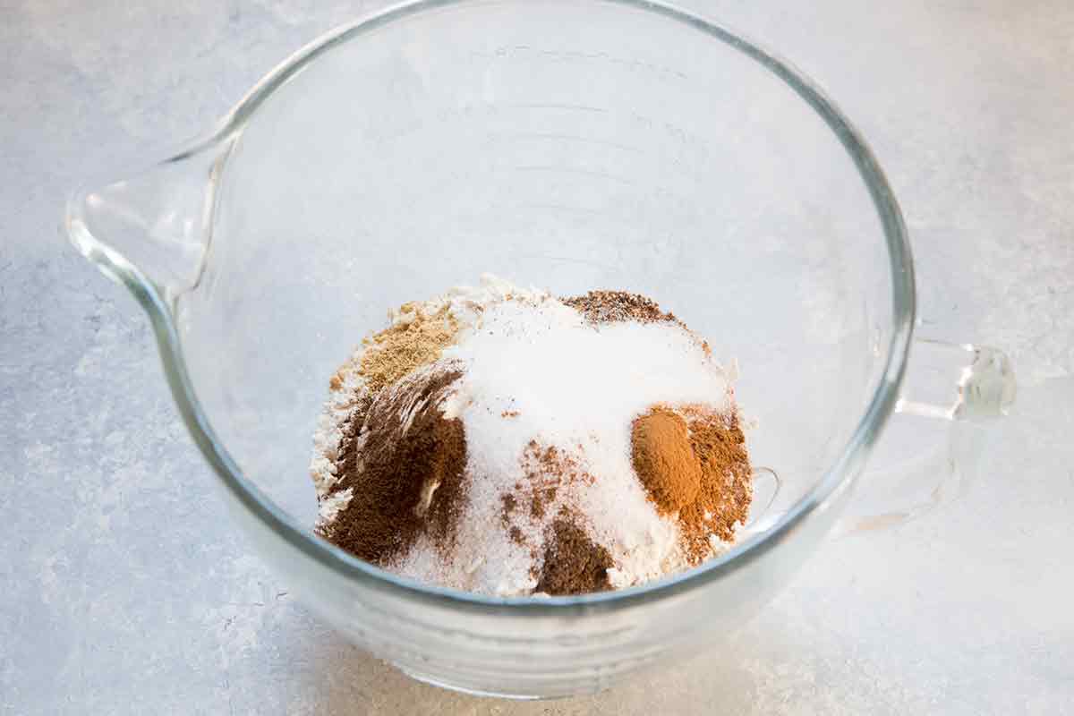 The dry ingredients for hot cross buns: flour, salt, spices, and sugar