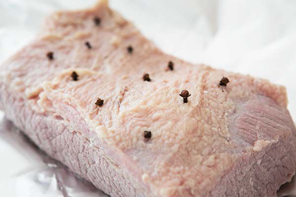 Evenly spaced cloves in slab of corned beef for corned beef and cabbage