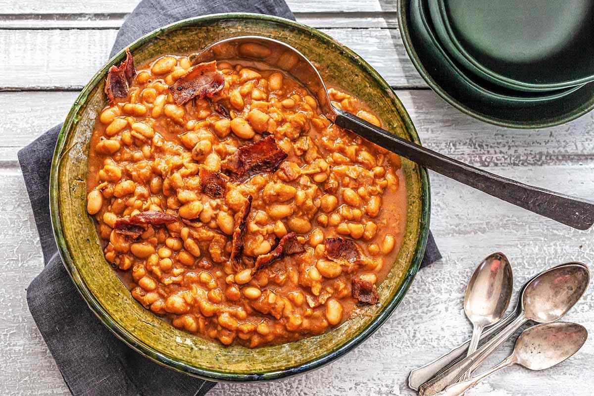How to Make Baked Beans - baked beans in a dish with a spoon