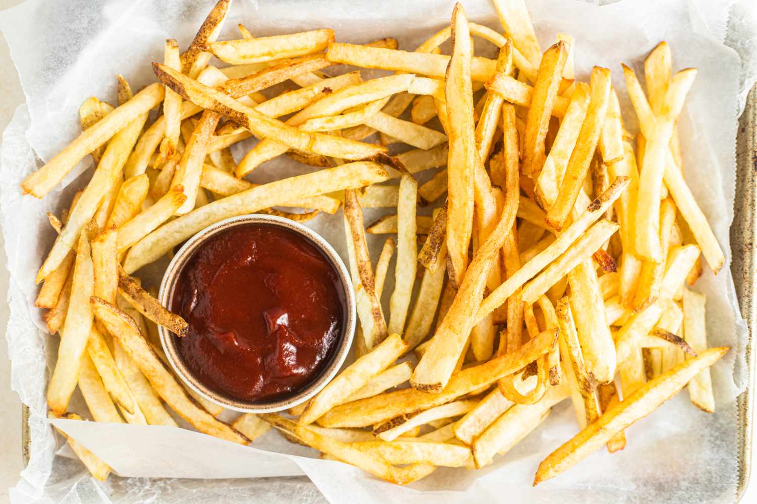 Tray of Homemade French Fries Served with a Bowl of Ketchup