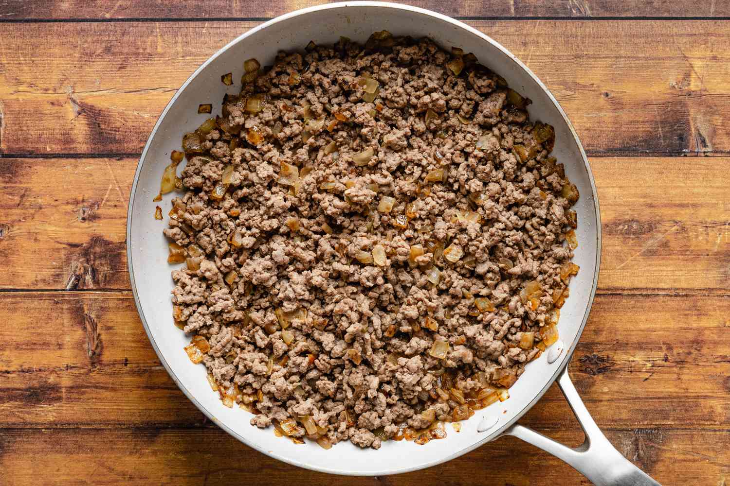ground beef cooked with the caramelized onions in a skillet for cheeseburger stuffed baked potatoes recipe