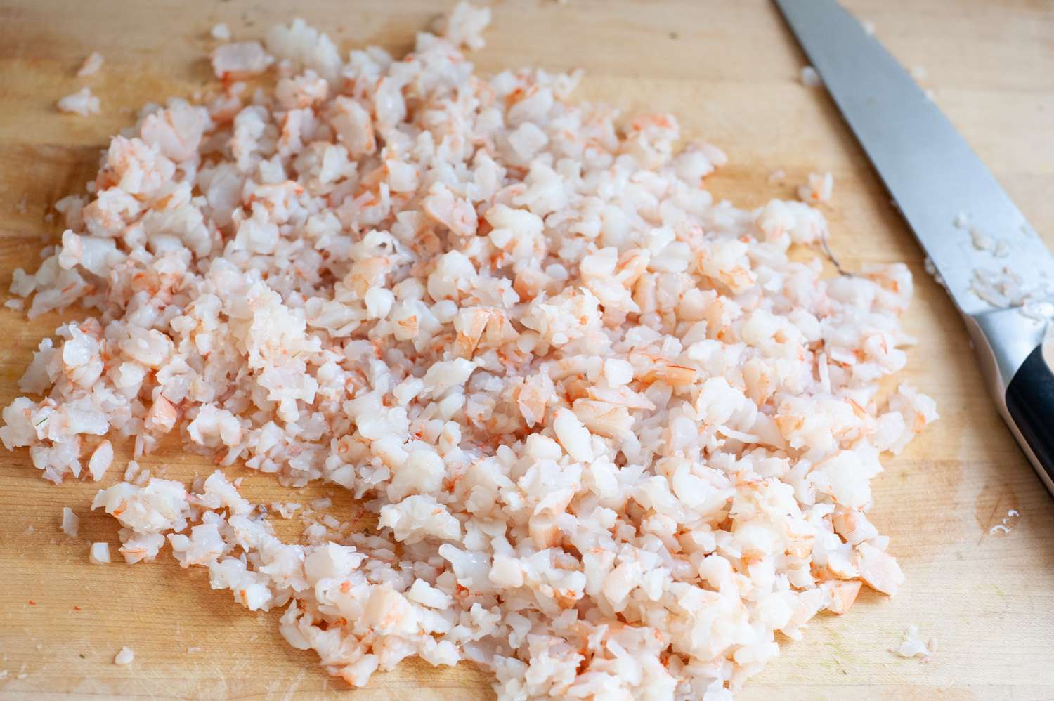 Shrimp Minced on a Cutting Board Using a Knife for Seafood Butter 