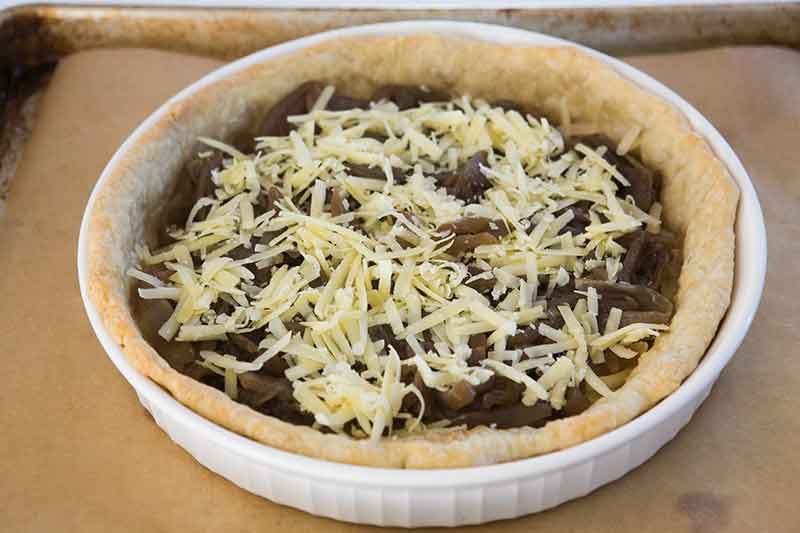 Caramelized onions and cheese added to the crust