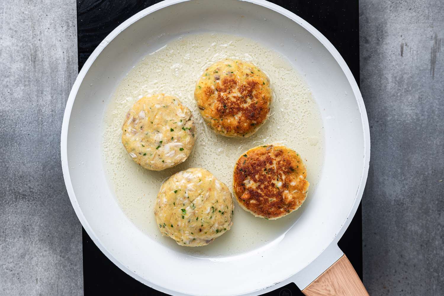 Cod Fish Cakes cooking in a pan