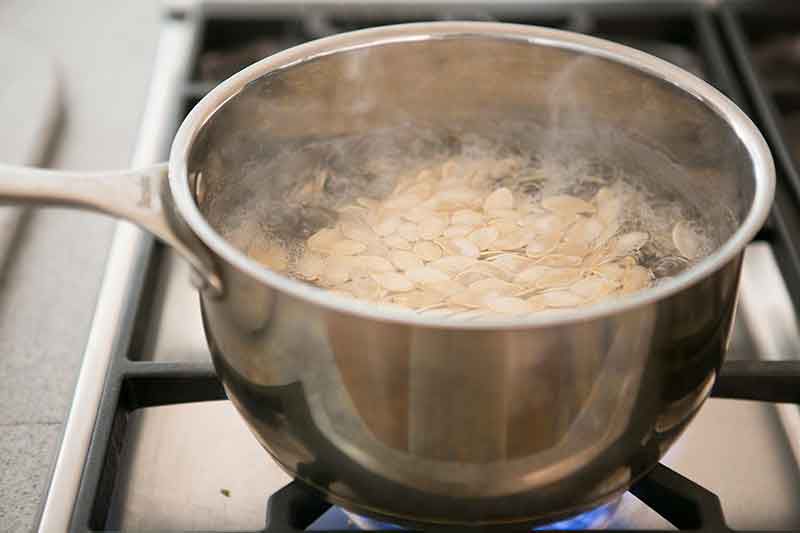 Boiling pumpkin seeds in salted water