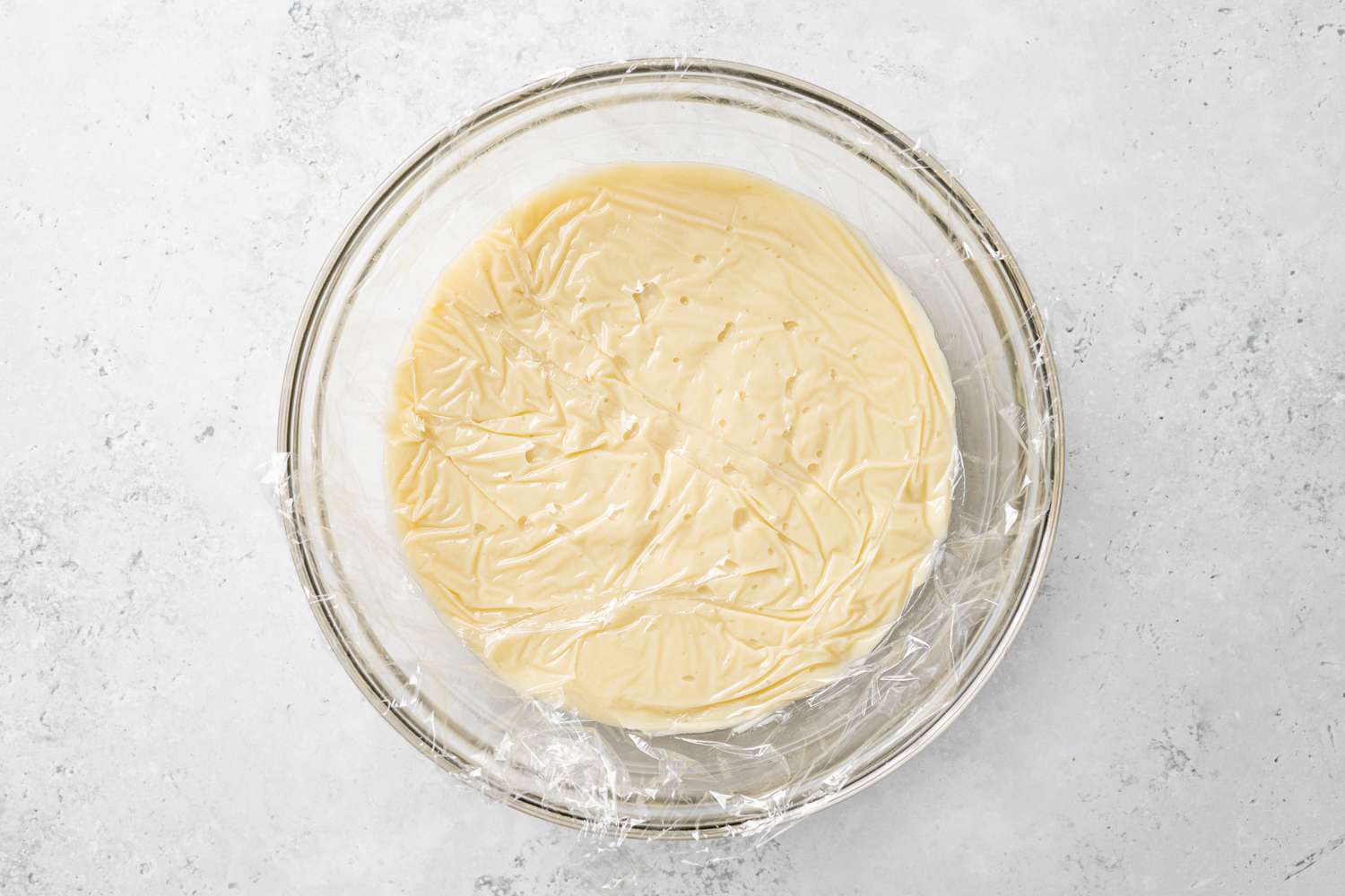 Bowl of Piña Colada Pie Custard Covered with Plastic Wrap