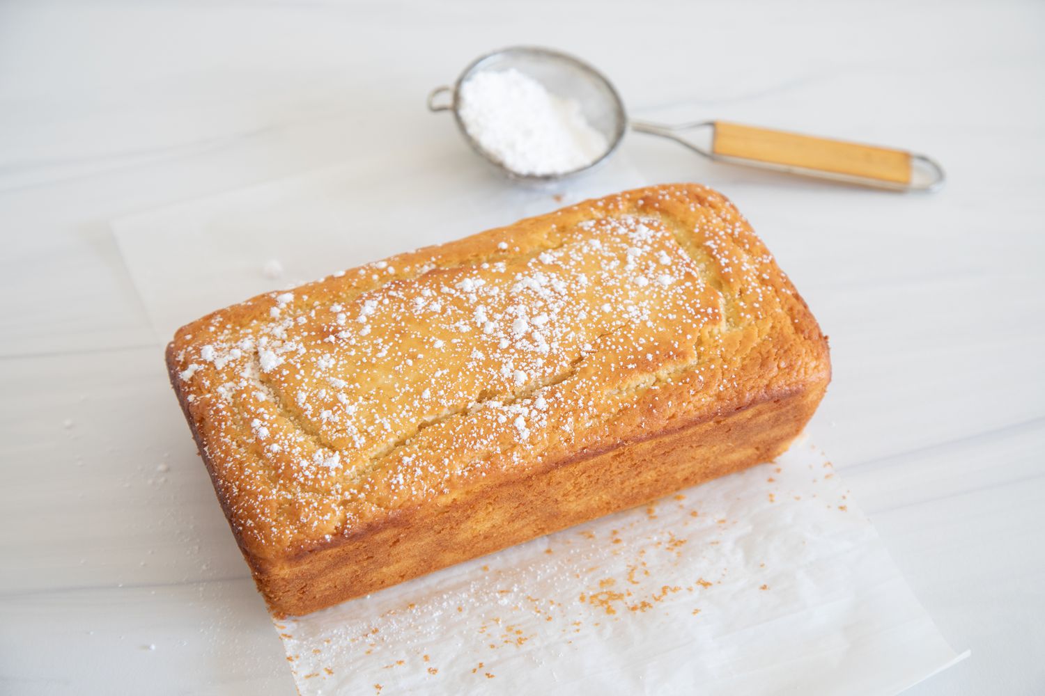 A loaf of Quick and Easy Yogurt Cake dusted with powdered sugar.