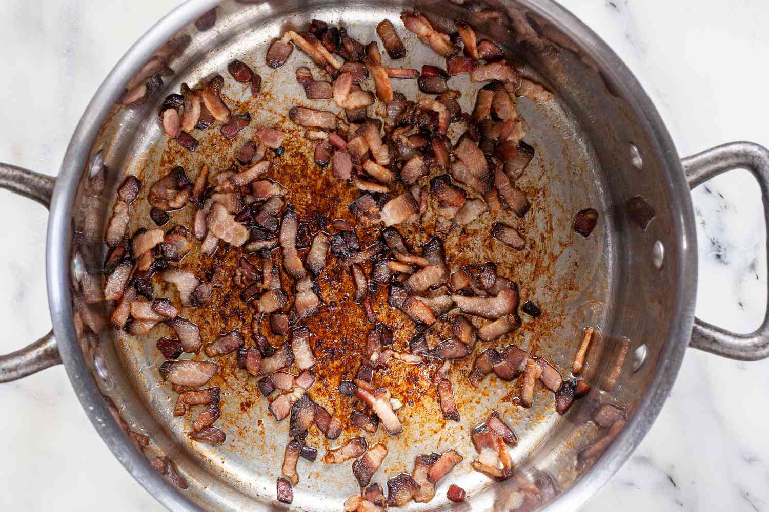 Pieces of Bacon Cooked in a Pot for Classic New England Chowder Recipe