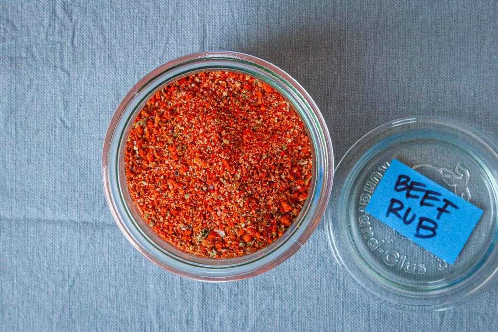 All Purpose Steak Spice Rub - overhead shot of red spices in jar