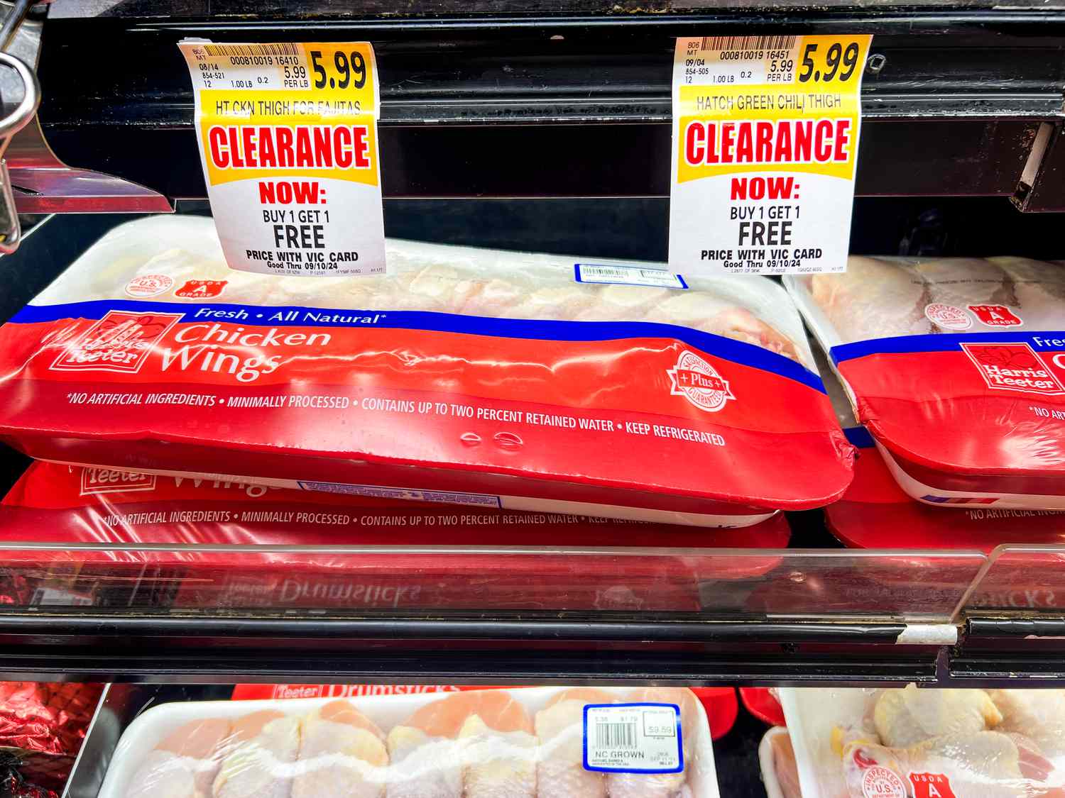 Chicken wings in a grocery store with clearance signs