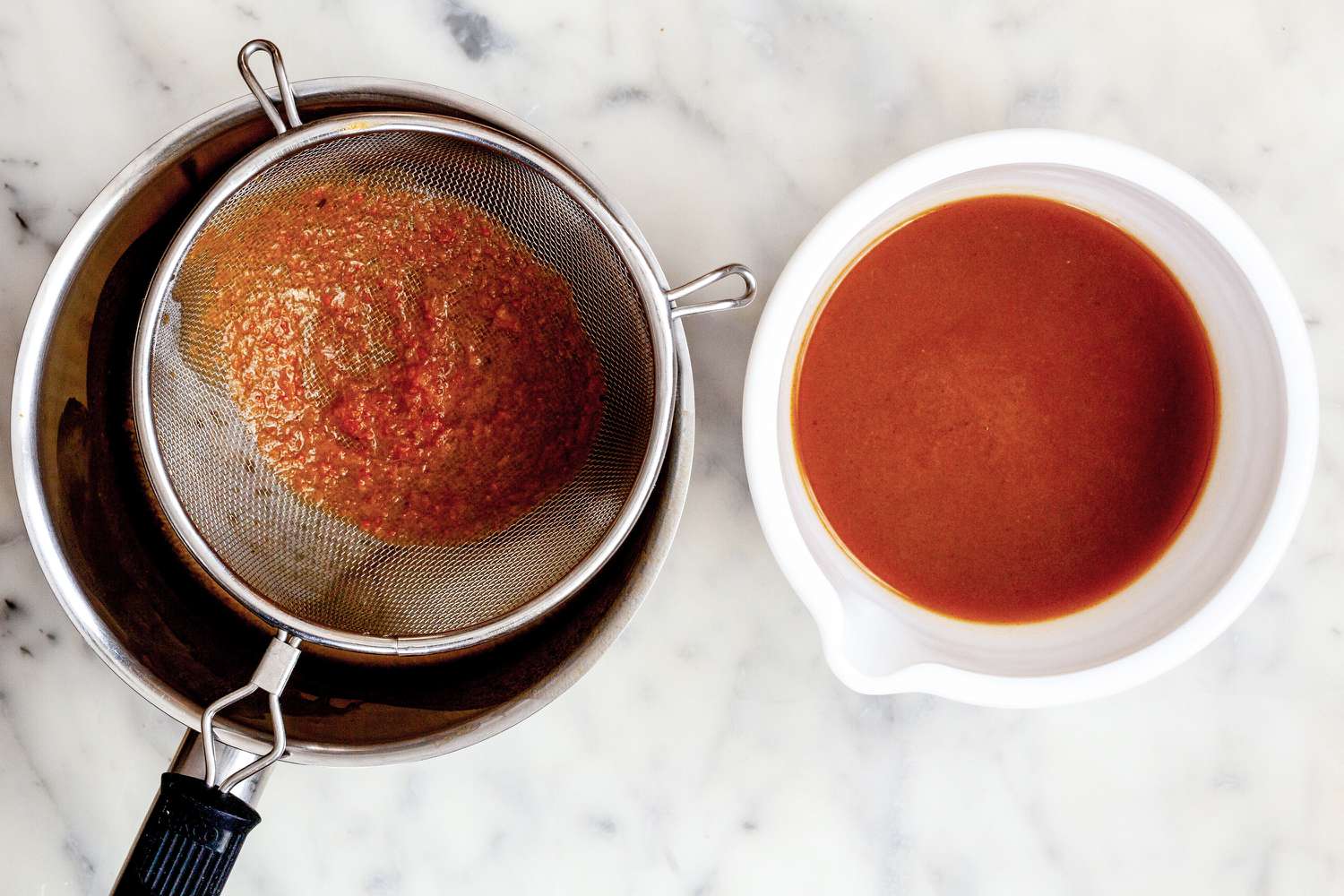 Classic demi-glace sauce strained into bowl
