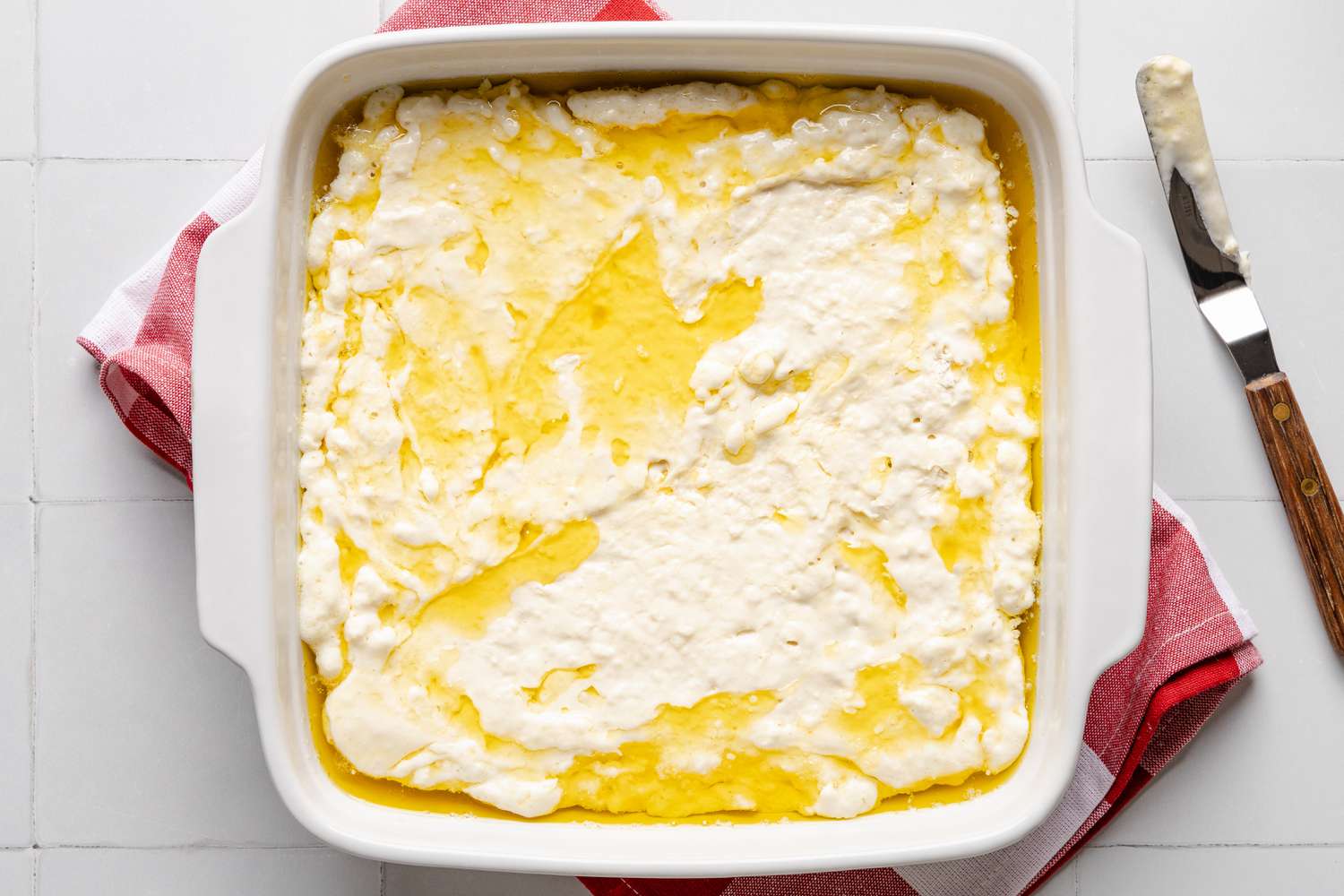 batter added to baking pan for butter swim biscuits recipe