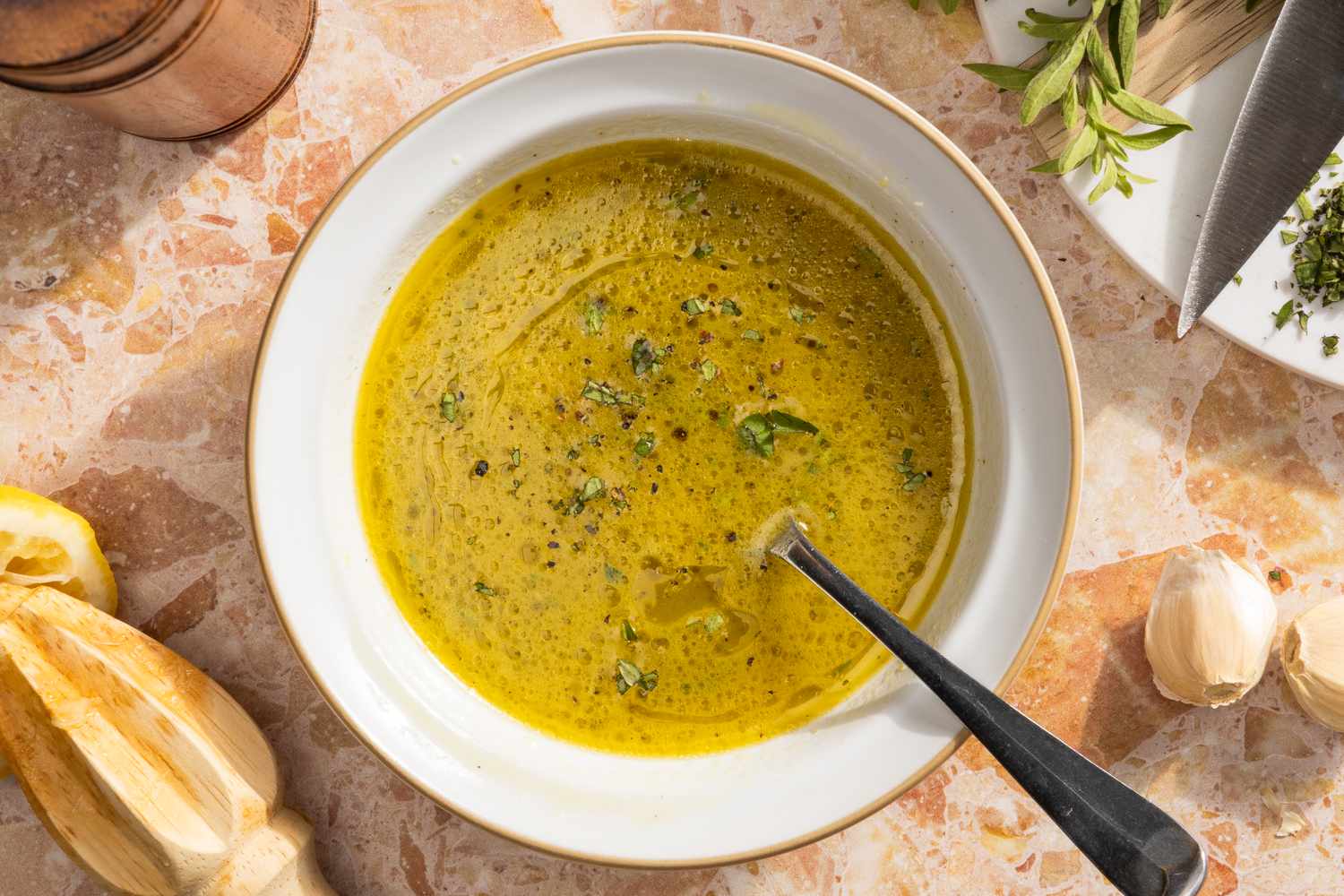 Mediterranean chicken marinade in a small white bowl with a spoon