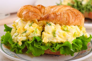Closeup of an egg salad sandwich on a croissant