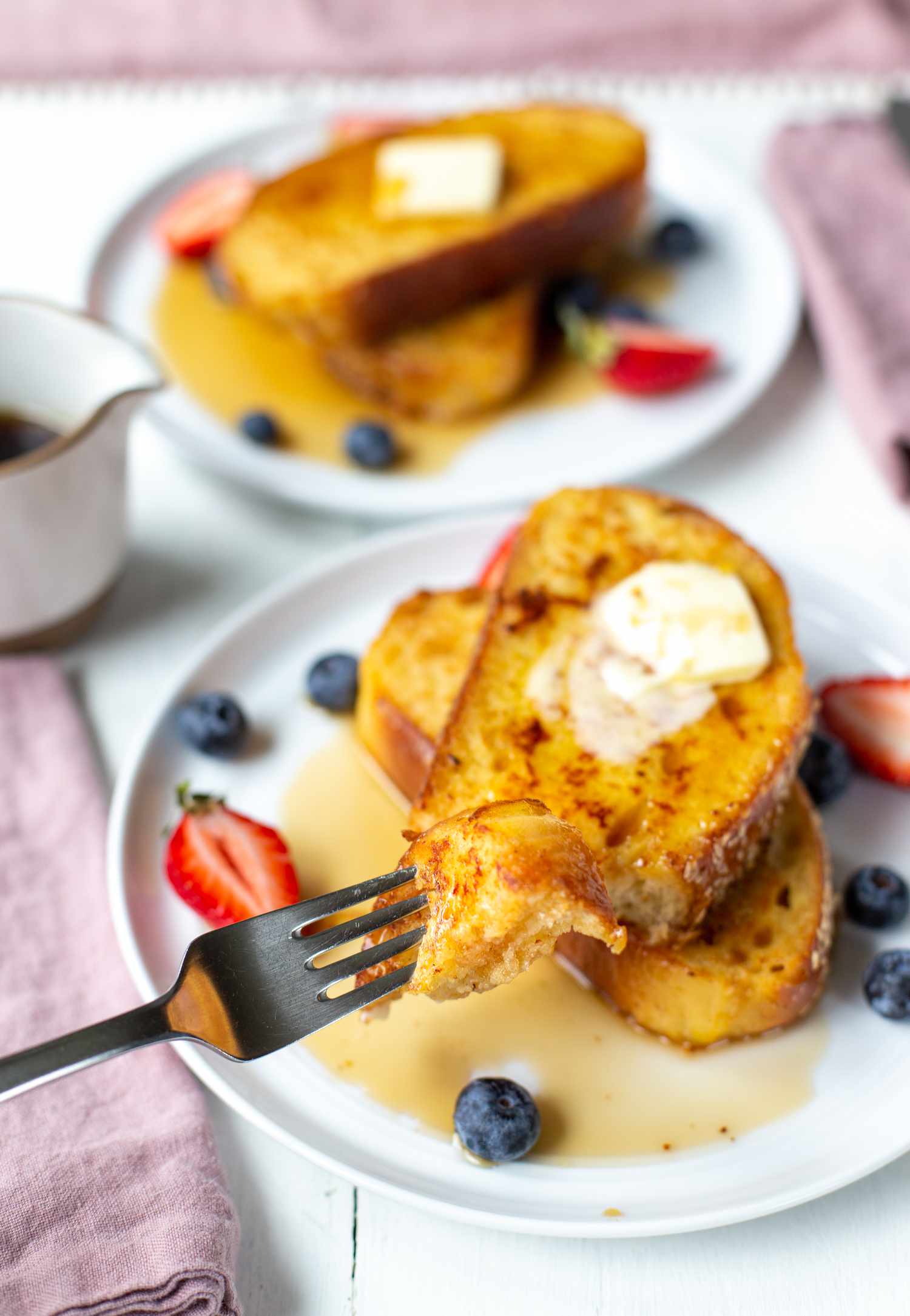 Challah French Toast on Fork with French Toast in Background