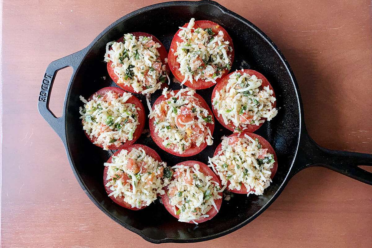 Cast iron skillet of the best stuffed tomatoes.