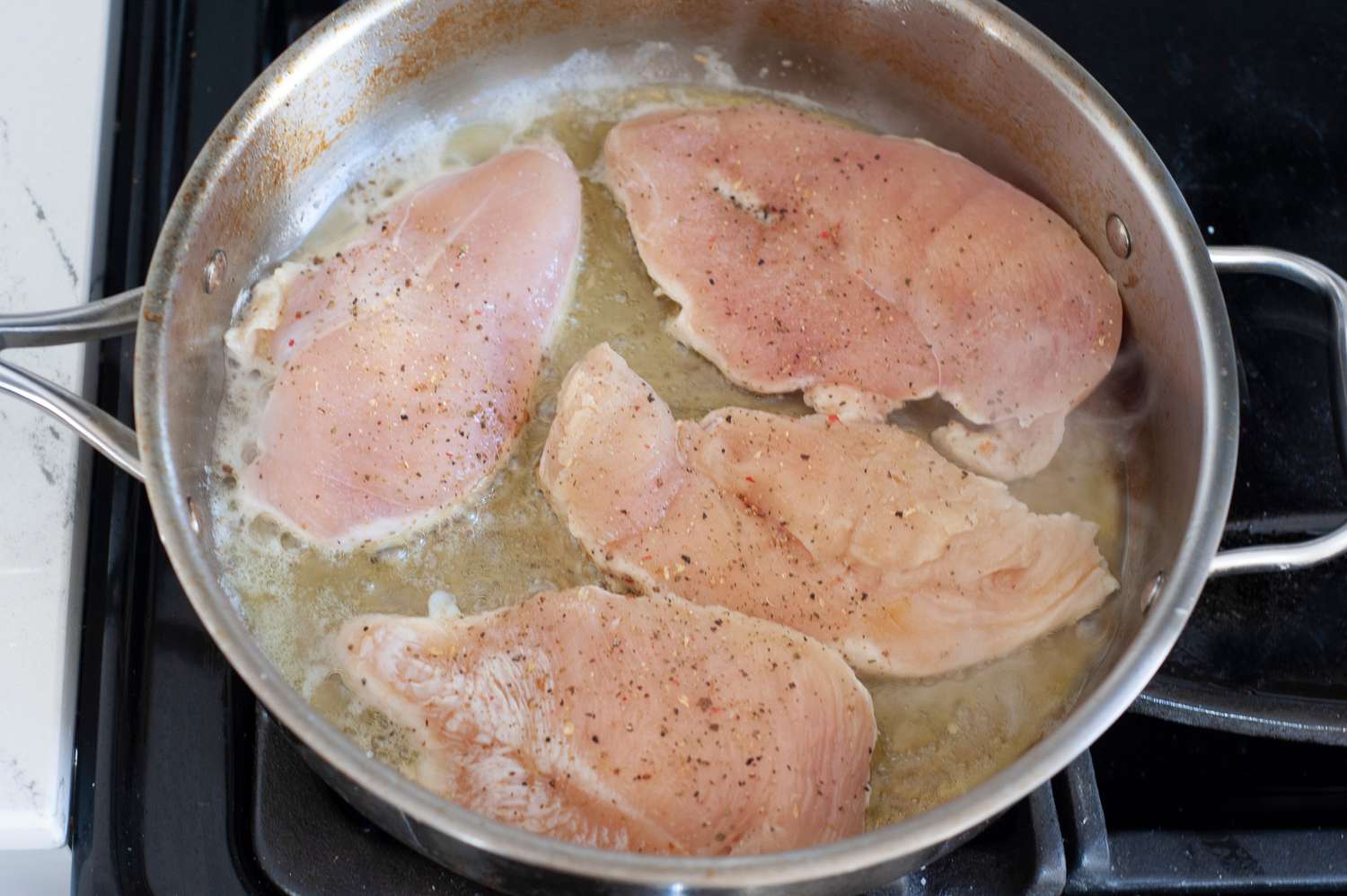 Brown chicken in skillet.