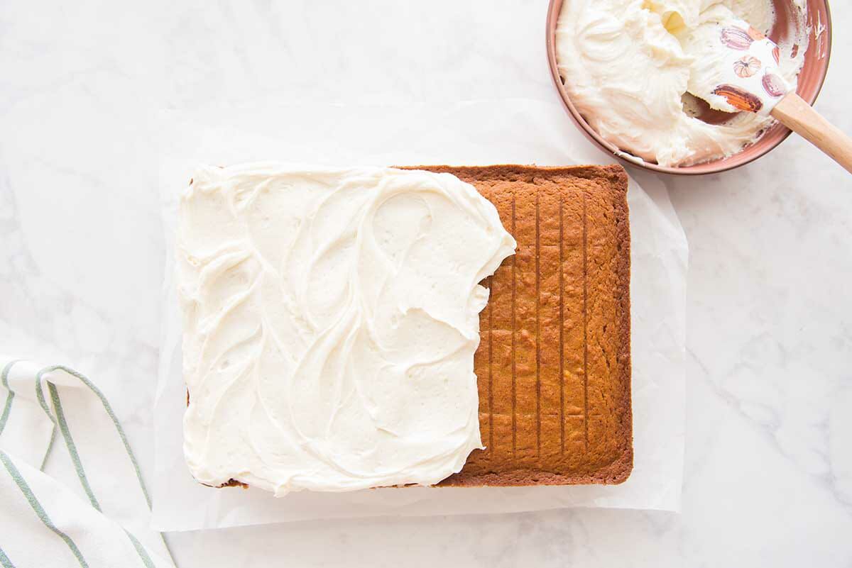 The Best Pumpkin Cake with Cream Cheese Frosting partially frosted.