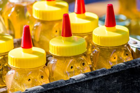 crate filled with jars of honey