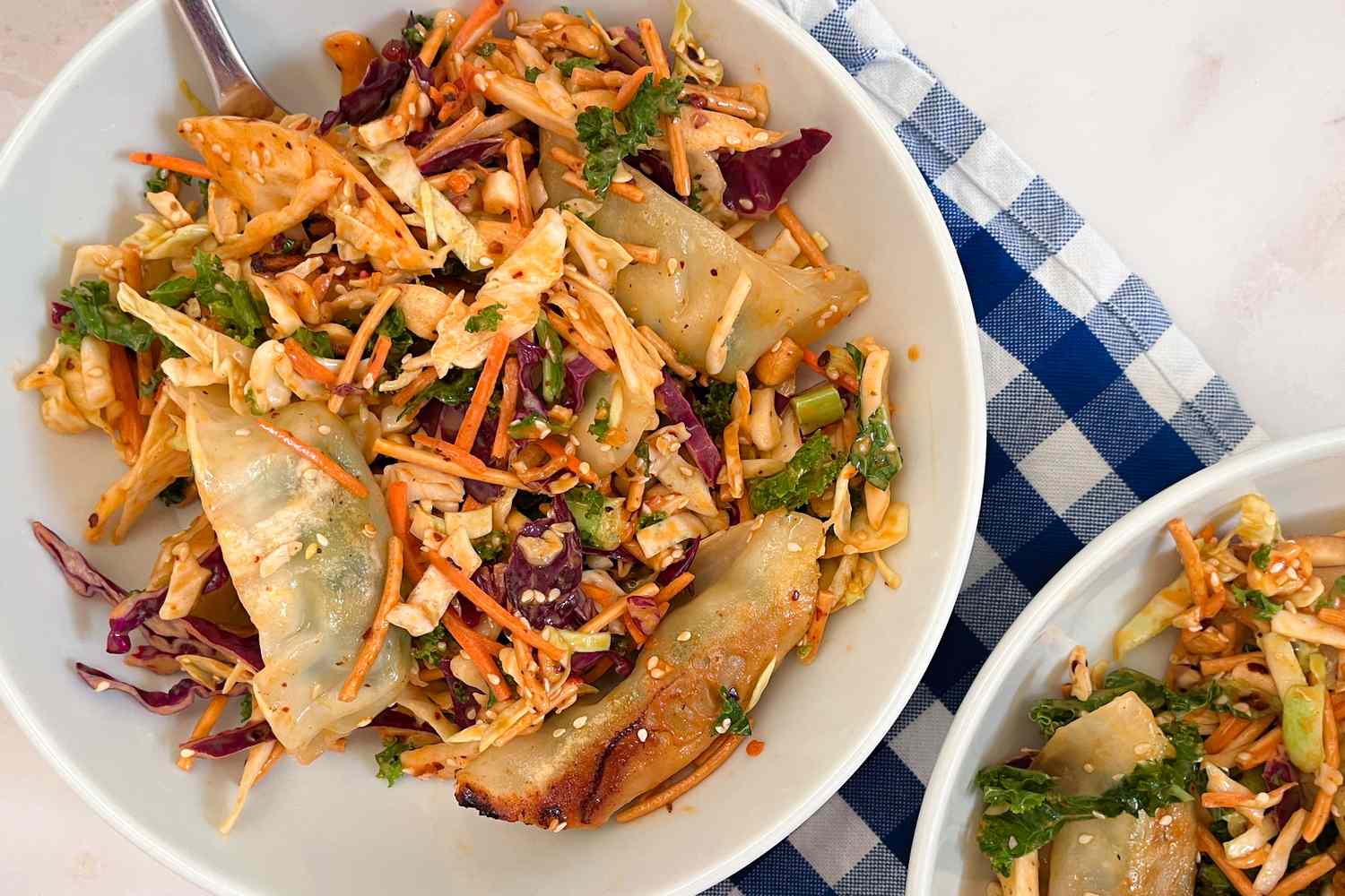 A bowl with the Trader Joe's Miso Crunch Chopped Salad Kit and dumplings