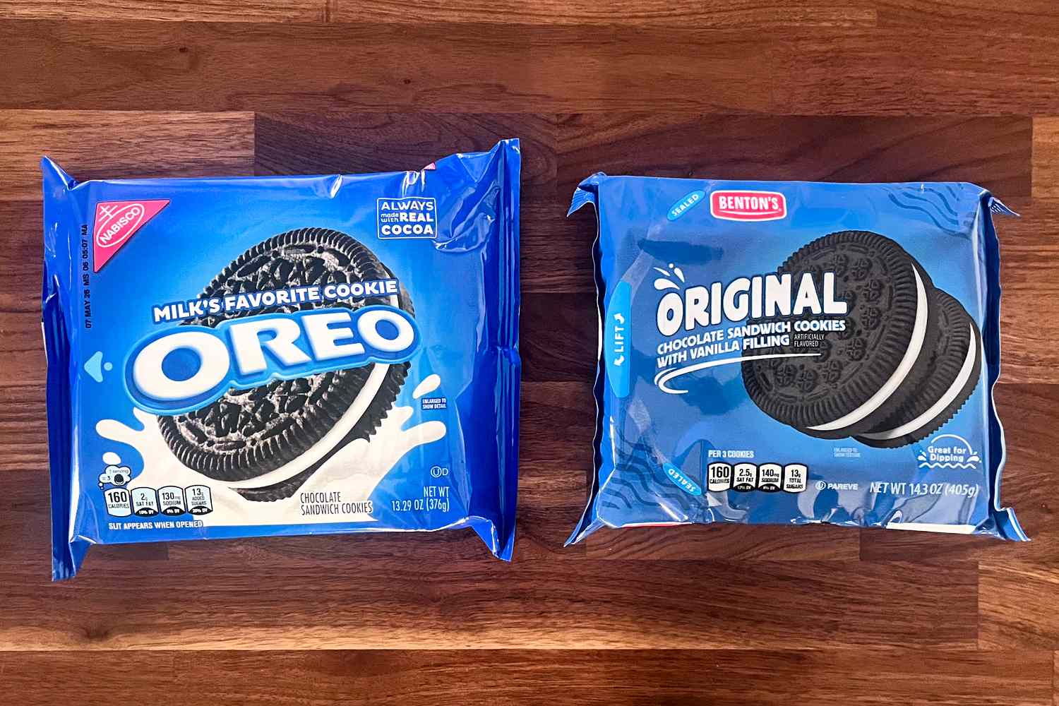 Two packages of sandwich cookies Oreo on the left and Bentons Original on the right placed on a wooden surface