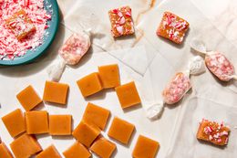 Peppermint Caramels with Some Wrapped in Wax Paper, Some Topped with Crushed Candy Cane, and Some Without Toppings, All Next to a Small Bowl of Crushed Candy Canes