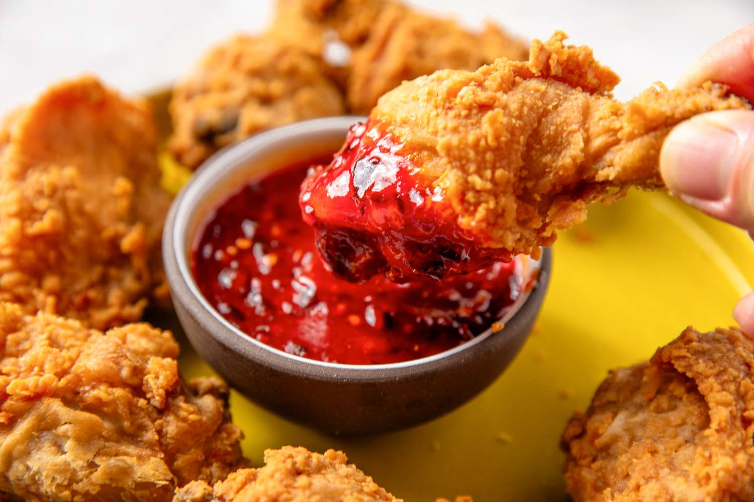 Fried chicken dipped in sweet and sour sauce
