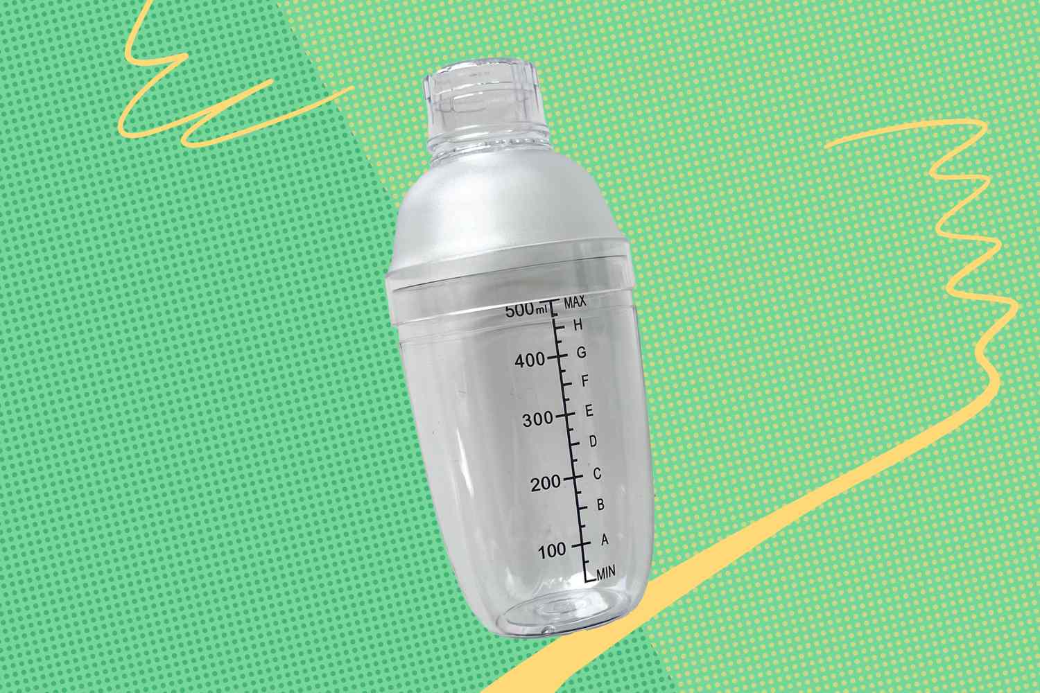 A clear cocktail shaker with measurement markings on a green background