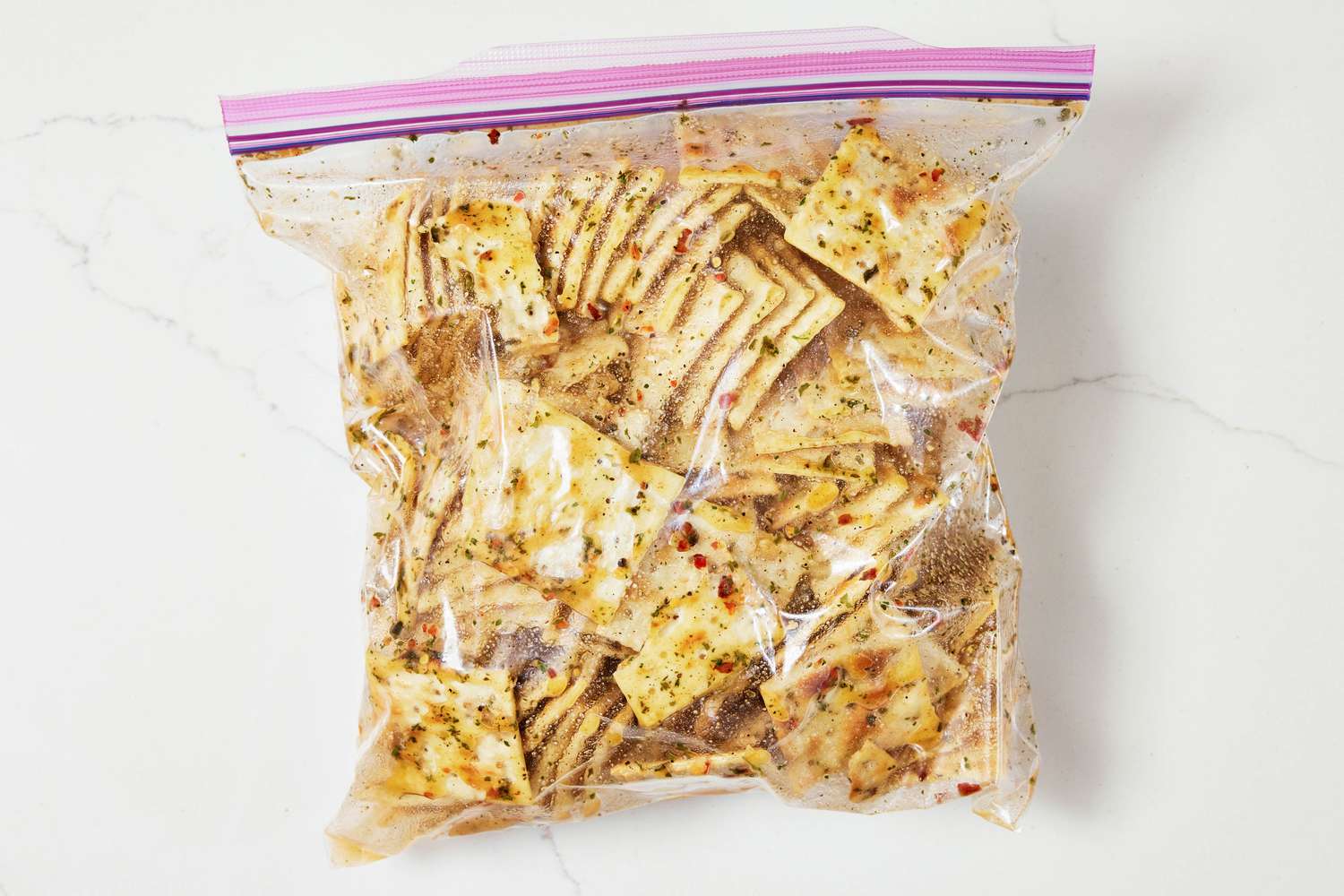 Saltines covered in seasoning oil in a large ziploc bag (zipped closed) for Alabama fire crackers recipe