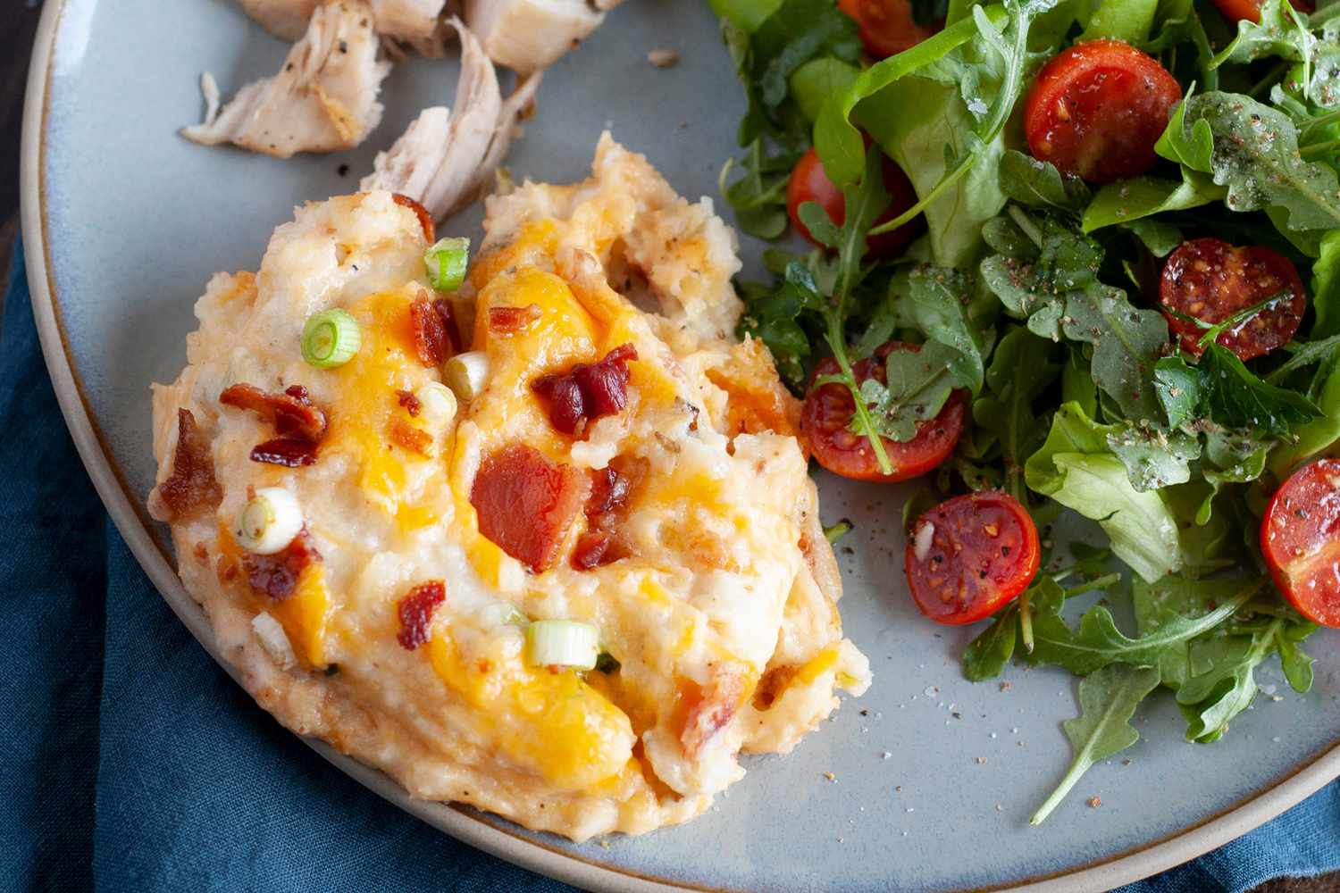 A helping of twice baked potato casserole on a plate